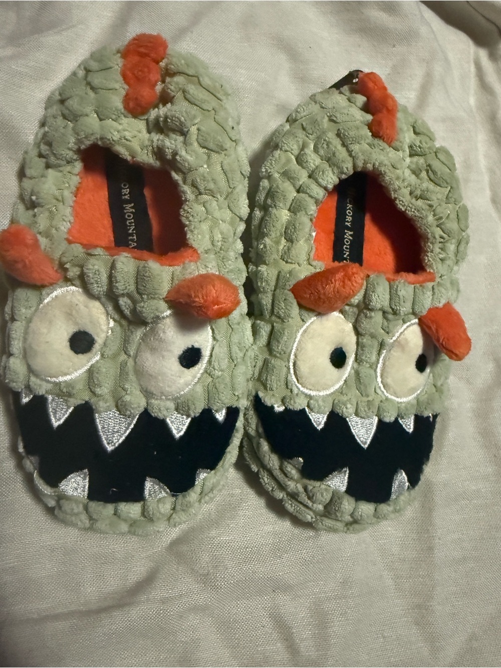 Cozy Monster Kids Sleep Sack Slippers in Light Green with Orange Details